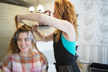 Seitenansicht einer Frau, die ihren Kunden die Haare färbt - CAVF35908