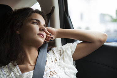 Thoughtful woman looking away while traveling in car - CAVF36003