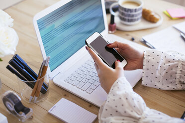 Hand of businesswoman holding smartphone - EBSF02360