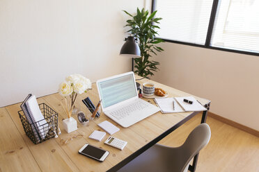 Laptop on desk in a bright and friendly office - EBSF02375