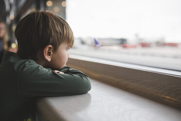 Boy looking through window of restaurant - MASF02651