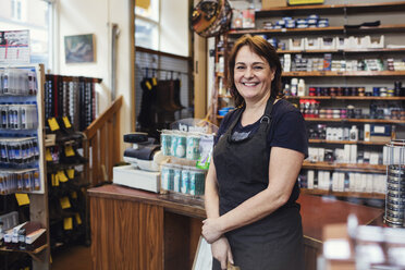 Portrait of happy shoemaker standing in shop - MASF02962