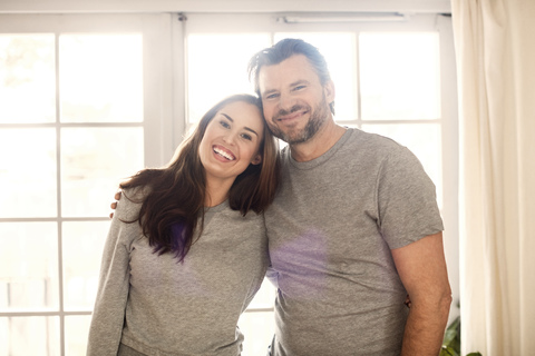 Portrait of happy father and daughter standing at new home stock photo