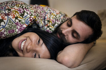 Happy couple relaxing on bed at home - CAVF36357