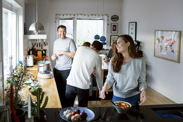 Happy family preparing food in kitchen - MASF03051