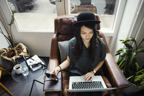 High angle view of creative businesswoman working while sitting on chair - MASF03086