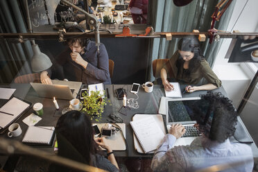 High angle view of creative team working at table in office seen through glass - MASF03089