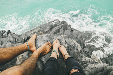 Low section of couple on rocks at Blowhole Beach - CAVF36531