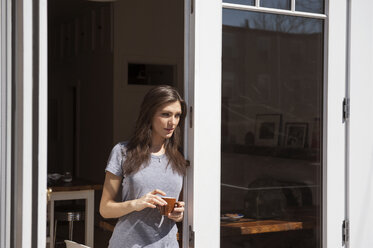 Young woman in t-shirt and panties at home standing at the window, Stock  Photo, Picture And Royalty Free Image. Pic. WES-KKAF01421