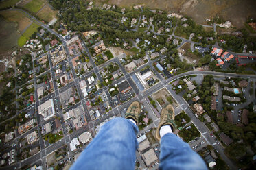 Low section of man paragliding over city - CAVF36678