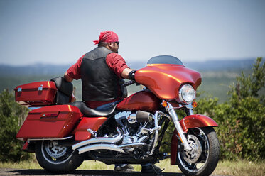 Rear view of man sitting on motorcycle - CAVF36738