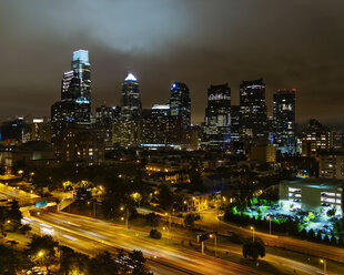 Illuminated buildings in city against cloudy sky - CAVF36780