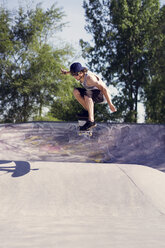 Young man doing skateboard trick on ramp - CAVF36996
