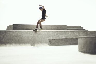 Young man performing stunts on skateboard - CAVF37018