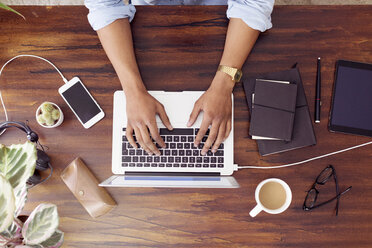 Directly above shot of businessman using laptop at desk in creative office - CAVF37103