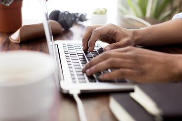 Cropped image of creative businessman using laptop at desk - CAVF37106