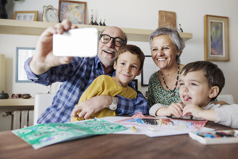 Fröhlicher älterer Mann macht Selfie mit Familie zu Hause - CAVF37140