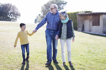 Happy grandparents with grandson on field - CAVF37161