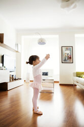 Side view of girl performing ballet dance at home - CAVF37185