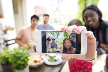 Multi-ethnic friends taking selfie at outdoor lunch table - CAVF37223