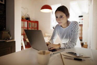 Frau arbeitet am Laptop am Tisch - CAVF37287