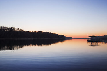 Scenic view of lake against clear sky at sunset - CAVF37462