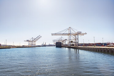 Scenic view of commercial dock at sea against sky - CAVF37502