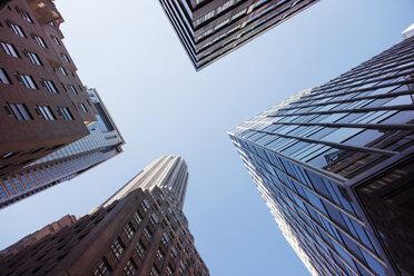 Directly below shot of modern buildings in city against clear sky - CAVF37505