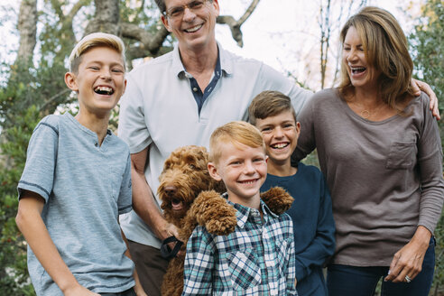 Glückliche Familie mit irischem Wolfshund im Park - CAVF37585