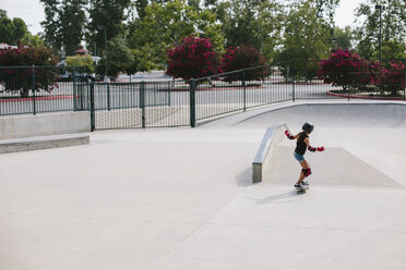 High angle view of girl skateboarding at park - CAVF37602