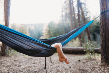 Low section of girl in hammock at campsite - CAVF37656