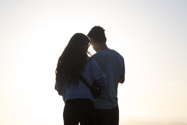 Rear view of couple standing against sky during sunset - CAVF37805