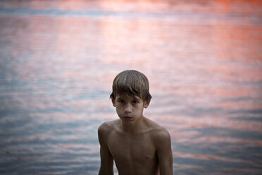 Boy by lake at sunset - CAVF37859