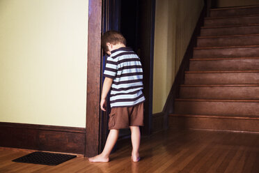 Boy standing against wall - CAVF37888