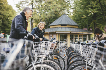 Senior people taking rental bikes at parking lot - MASF03303