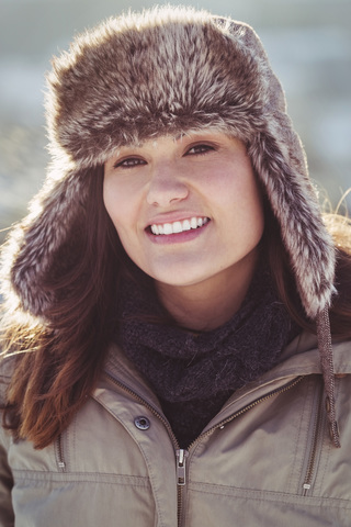 Portrait of happy women in warm clothing standing outdoors during winter stock photo