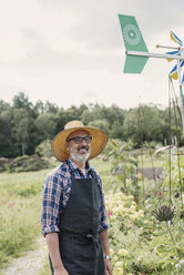 Portrait of happy farmer standing in farm against sky - MASF03383