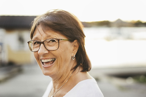Porträt einer selbstbewussten älteren Frau, die im Freien lächelt, lizenzfreies Stockfoto