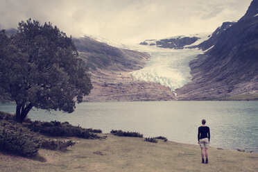 Rear view of woman looking at lake and mountains - MASF03432