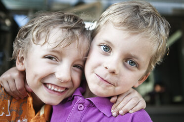 Portrait of a two playful brothers with arms around - MASF03457