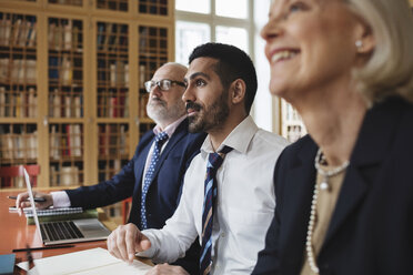 Male and female professionals listening in meeting - MASF03503