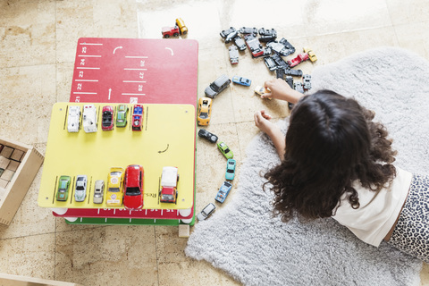 High angle view of girl playing with toy car in day care center stock photo