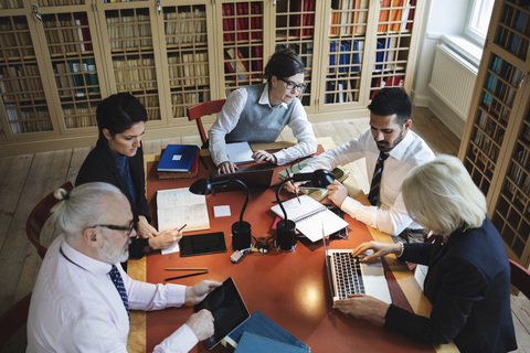 High angle view of professionals working at table in law library stock photo