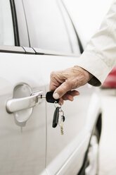 Cropped image of woman inserting key in car door - MASF03658