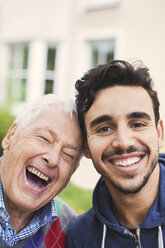 Close-up portrait of caretaker with happy senior man outside nursing home - MASF03685