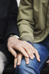Cropped image of senior man touching caretaker's hand - MASF03686