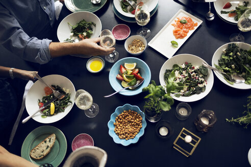 Cropped image of friends eating food at table - MASF03735