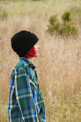 Side view of boy standing on field - CAVF38091