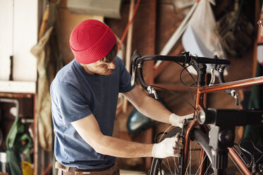 Mechanic repairing bicycle at workshop - CAVF38127