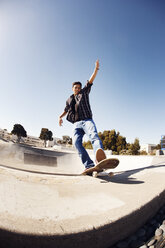Niedriger Blickwinkel von Mann Skateboarden im Park gegen klaren blauen Himmel - CAVF38180